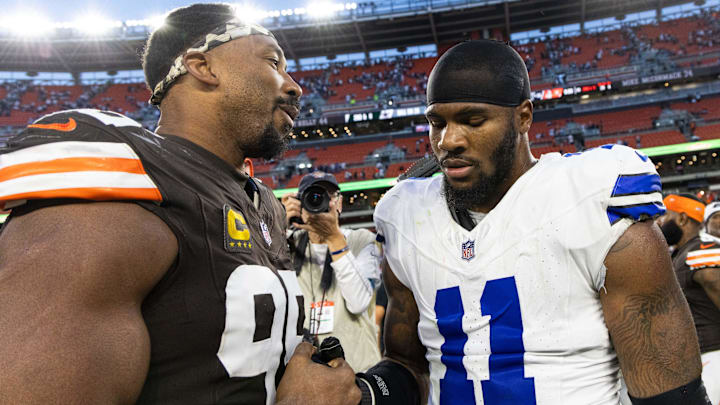 Cleveland Browns defensive end Myles Garrett (95) congratulates Dallas Cowboys linebacker Micah Parsons (11) after the game at Huntington Bank Field.