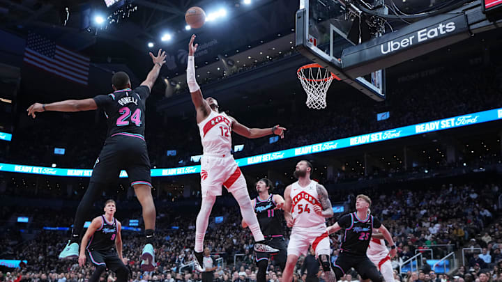 Apr 7, 2026; Toronto, Ontario, CAN; Toronto Raptors forward Scottie Barnes (4) battles for the ball with Miami Heat guard Norman Powell (24) during the third quarter at Scotiabank Arena. Mandatory Credit: Nick Turchiaro-Imagn Images