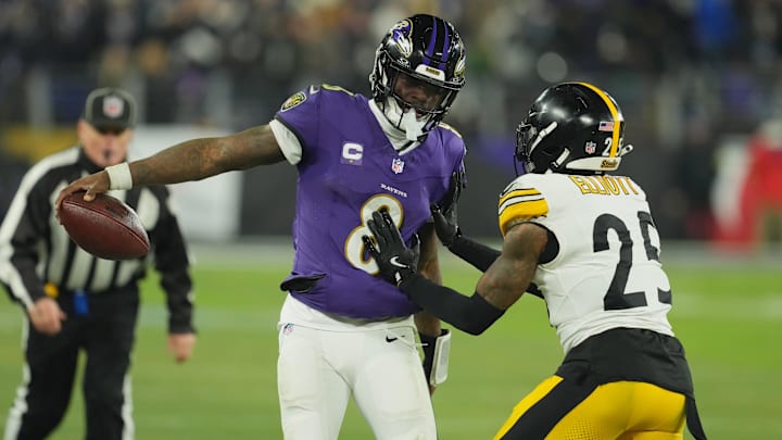 Jan 11, 2025; Baltimore, Maryland, USA; Baltimore Ravens quarterback Lamar Jackson (8) runs against Pittsburgh Steelers safety DeShon Elliott (25) in the second quarter in an AFC wild card game at M&T Bank Stadium. Mandatory Credit: Mitch Stringer-Imagn Images