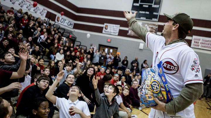Scooter Gennett, second baseman for the Cincinnati Reds, throws candy to students at Heritage Middle School, Friday January 18, during an assembly at the school. Gennett and other Reds players were on a caravan tour visiting schools. The players answered questions from students while Mr. Red the team mascot entertained the crowd. 

Reds At Heritage 02