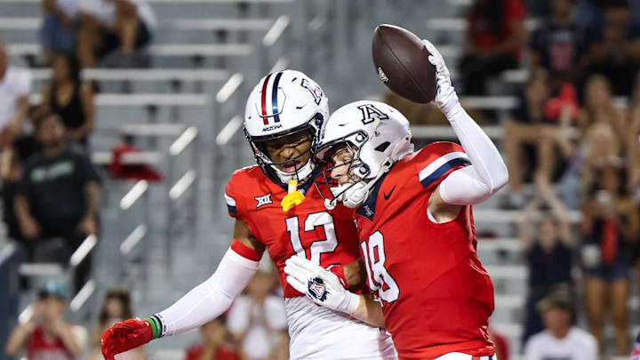 Sep 6, 2025; Tucson, Arizona, USA; Arizona Wildcats wide receiver Brandon Phelps (18) celebrates a touchdown with wide receiver Tre Spivey (12) during the second quarter of the game against the Weber State Wildcats  at Arizona Stadium. Mandatory Credit: Aryanna Frank-Imagn Images