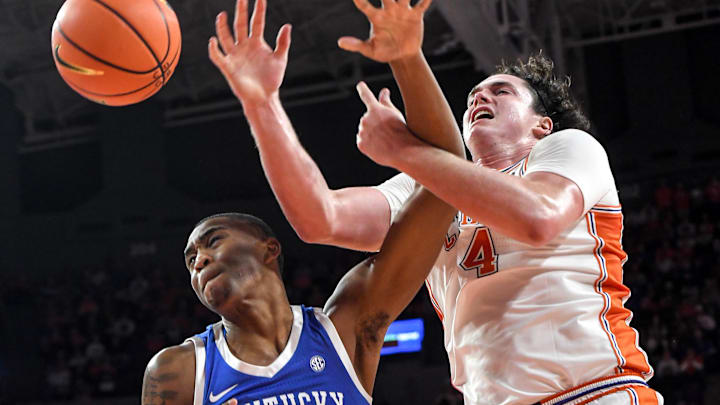 Dec 3, 2024; Clemson, South Carolina, USA; Kentucky forward Brandon Garrison (10) and Clemson senior forward Ian Schieffelin (4) reach for a loose ball during the first half at Littlejohn Coliseum. Mandatory Credit: Ken Ruinard-Imagn Images
