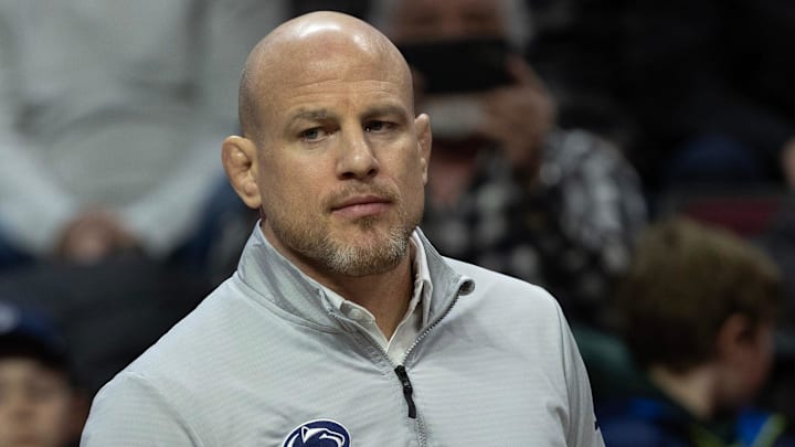 Penn State wrestling coach Cael Sanderson watches as the Nittany Lions defeat Rutgers in a Big Ten match.