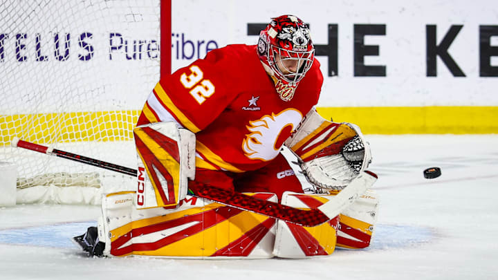 Apr 15, 2025; Calgary, Alberta, CAN; Calgary Flames goaltender Dustin Wolf (32) makes a save against the Vegas Golden Knights during the third period at Scotiabank Saddledome. Mandatory Credit: Sergei Belski-Imagn Images