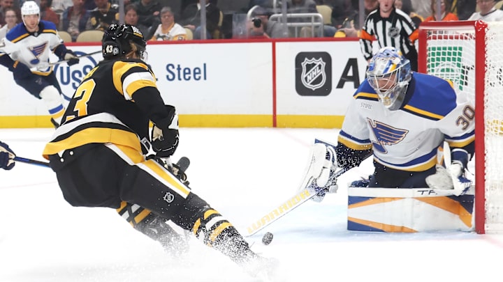 Mar 13, 2025; Pittsburgh, Pennsylvania, USA; St. Louis Blues goaltender Joel Hofer (30) makes a save against Pittsburgh Penguins left wing Danton Heinen (43) during the third period at PPG Paints Arena. Mandatory Credit: Charles LeClaire-Imagn Images