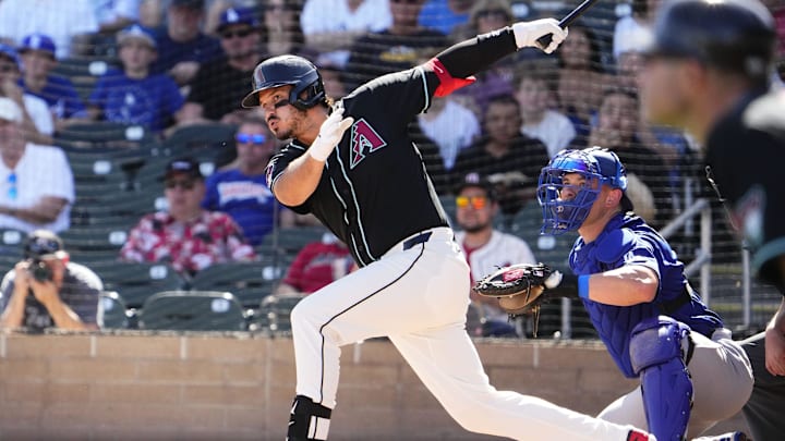 Arizona Diamondbacks third baseman Nolan Arenado (28) hits an RBI-double against the Los Angeles Dodgers in the first inning on Feb. 25, 2026, at Salt River Fields in Scottsdale. Arizona Diamondbacks third baseman Nolan Arenado (28) hits an RBI-double against the Los Angeles Dodgers in the first inning on Feb. 25, 2026, at Salt River Fields in Scottsdale.