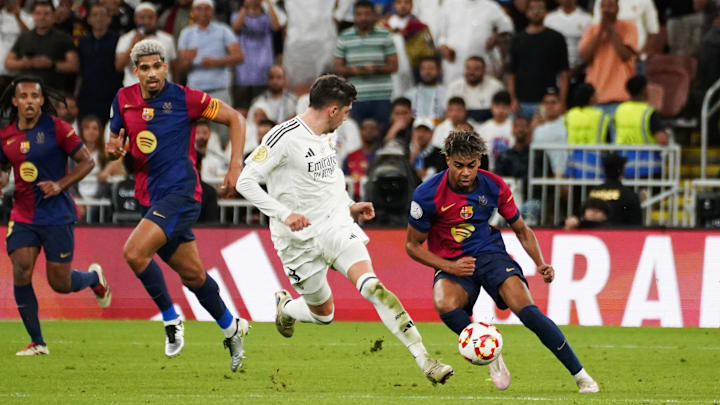 Barcelona's Spanish player Lamine Yamal (R) seen in action...