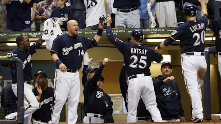 Oct 2, 2011; Milwaukee, WI, USA; Milwaukee Brewers players Mark Kotsay (25) and Jonathan Lucroy (20) are welcomed back to the dugout after scoring runs in the sixth inning of game two of the 2011 NLDS against the Arizona Diamondbacks at Miller Park. Mandatory Credit: Jerry Lai-Imagn Images Oct 2, 2011; Milwaukee, WI, USA; Milwaukee Brewers players Mark Kotsay (25) and Jonathan Lucroy (20) are welcomed back to the dugout after scoring runs in the sixth inning of game two of the 2011 NLDS against the Arizona Diamondbacks at Miller Park. Mandatory Credit: Jerry Lai-Imagn Images