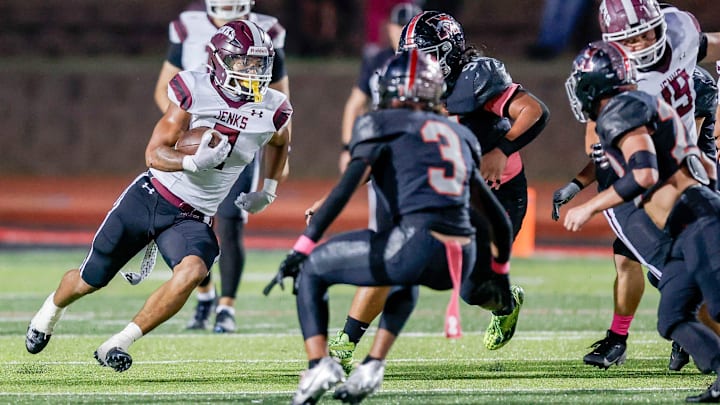 Jenks’ Kaydin Jones (2) runs the ball during a high school football game between Mustang and Jenks in Mustang, Okla., on Friday, Oct. 11, 2024.