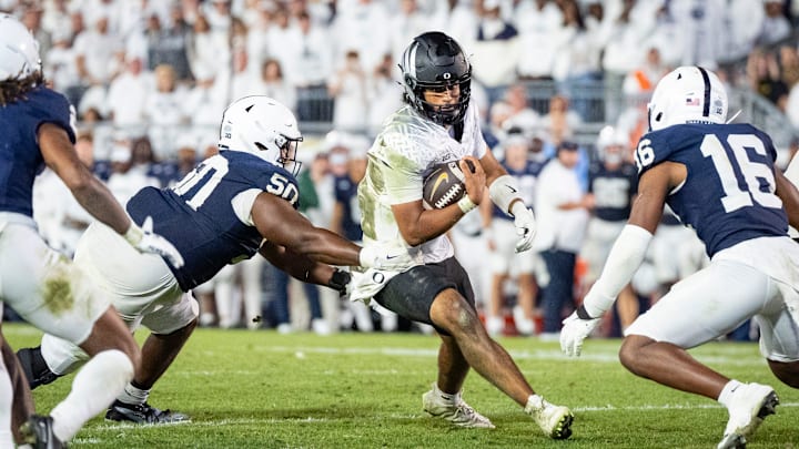 Oregon quarterback Dante Moore carries the ball as the Oregon Ducks face the Penn State Nittany Lions on Sept. 27, 2025, at Beaver Stadium in University Park, Pennsylvania.