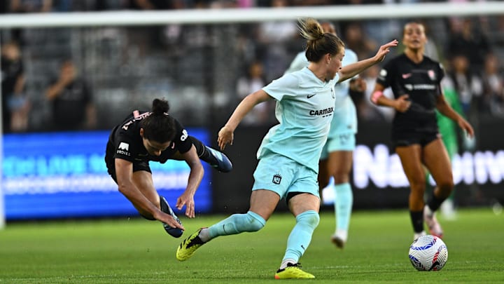Jul 6, 2024; Los Angeles, California, USA; NJ/NY Gotham FC midfielder Emily Sonnett (6) steals the ball from Angel City FC midfielder Rocky Rodriguez (7) during the first half at BMO Stadium. Mandatory Credit: Kelvin Kuo-USA TODAY Sports