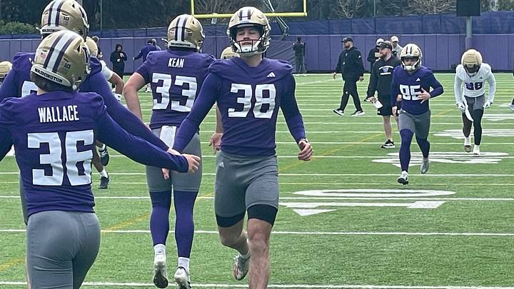 Hunter McKee (38) slaps hands with CJ Wallace during spring ball.