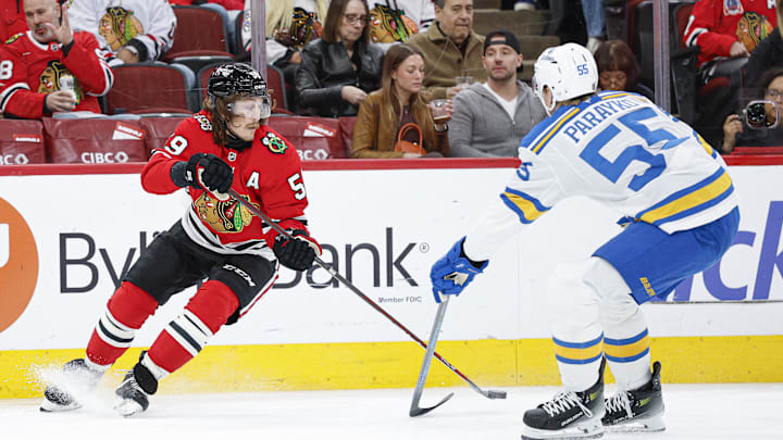 Apr 11, 2026; Chicago, Illinois, USA; Chicago Blackhawks left wing Tyler Bertuzzi (59) passes the puck against St. Louis Blues defenseman Colton Parayko (55) during the first period at United Center. Mandatory Credit: Kamil Krzaczynski-Imagn Images