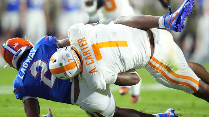 Tennessee linebacker Arion Carter (7) takes down Florida quarterback DJ Lagway (2) in an NCAA college football game on November 22, 2025, in Gainesville, Florida.