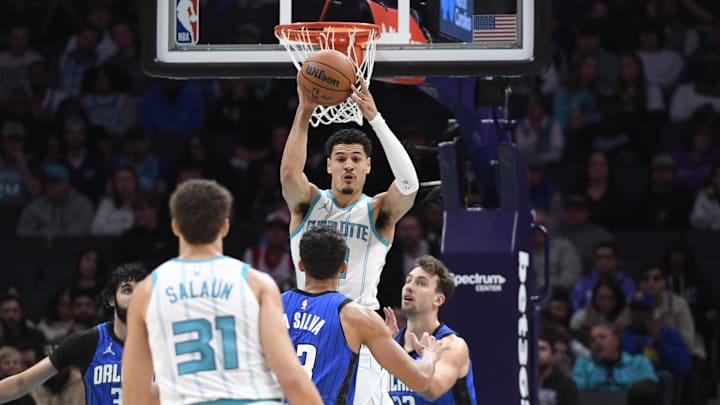 Nov 25, 2024; Charlotte, North Carolina, USA;  Charlotte Hornets guard Josh Green (10) looks to pass to forward Tidjane Salaun (31) during the first half against the Orlando Magic at the Spectrum Center. Mandatory Credit: Sam Sharpe-Imagn Images