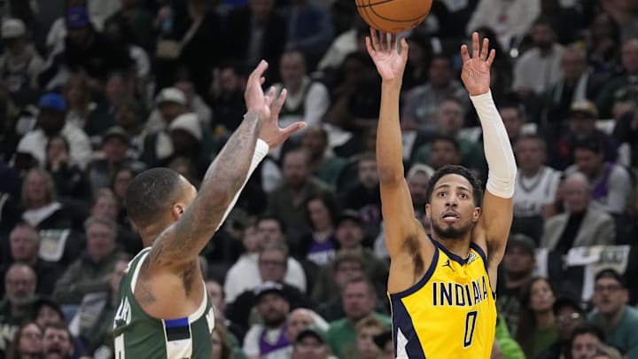 Apr 25, 2025; Milwaukee, Wisconsin, USA; Indiana Pacers guard Tyrese Haliburton (0) puts up a shot against Milwaukee Bucks guard Damian Lillard (0) in the first half during game three of first round for the 2024 NBA Playoffs at Fiserv Forum. Mandatory Credit: Michael McLoone-Imagn Images