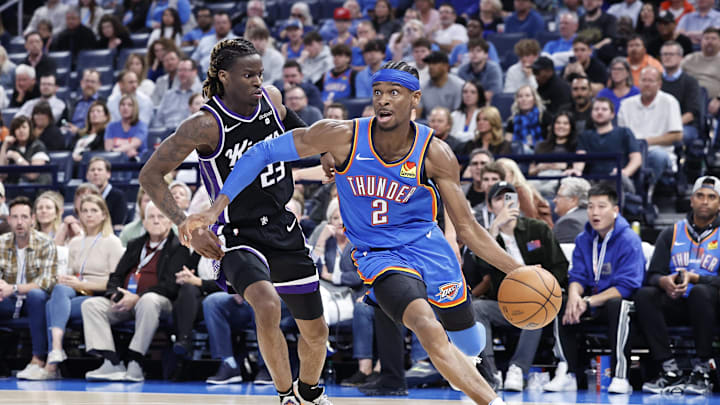 Apr 9, 2024; Oklahoma City, Oklahoma, USA; Oklahoma City Thunder guard Shai Gilgeous-Alexander (2) drives the ball around Sacramento Kings guard Keon Ellis (23) during the second half at Paycom Center. Mandatory Credit: Alonzo Adams-Imagn Images
