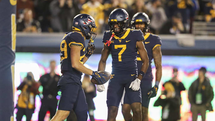 Nov 4, 2023; Morgantown, West Virginia, USA; West Virginia Mountaineers wide receiver Preston Fox (29) catches a pass for a touchdown and celebrates with West Virginia Mountaineers wide receiver Traylon Ray (7) during the second quarter against the Brigham Young Cougars at Mountaineer Field at Milan Puskar Stadium. Mandatory Credit: Ben Queen-Imagn Images