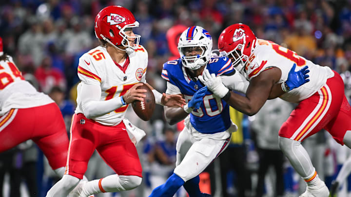 Nov 17, 2024; Orchard Park, New York, USA; Kansas City Chiefs quarterback Patrick Mahomes (15) is pressured by Buffalo Bills defensive end Greg Rousseau (50) who's being blocked by guard Trey Smith (65) in the third quarter at Highmark Stadium. Mandatory Credit: Mark Konezny-Imagn Images