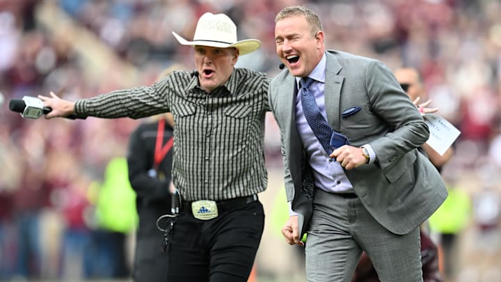 Dec 20, 2025; College Station, TX, USA; Kirk Herbstreit and Pat McAfee celebrate prior to the game between the Miami Hurricanes and the Texas A&M Aggies during the first round of the CFP National Playoff at Kyle Field. Mandatory Credit: Maria Lysaker-Imagn Images