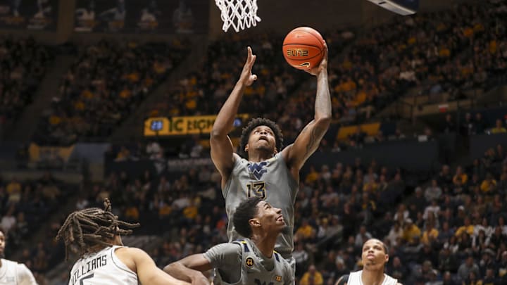 Mar 8, 2025; Morgantown, West Virginia, USA; West Virginia Mountaineers forward Amani Hansberry (13) shoots in the lane against the UCF Knights during the first half at WVU Coliseum. Mar 8, 2025; Morgantown, West Virginia, USA; West Virginia Mountaineers forward Amani Hansberry (13) shoots in the lane against the UCF Knights during the first half at WVU Coliseum.