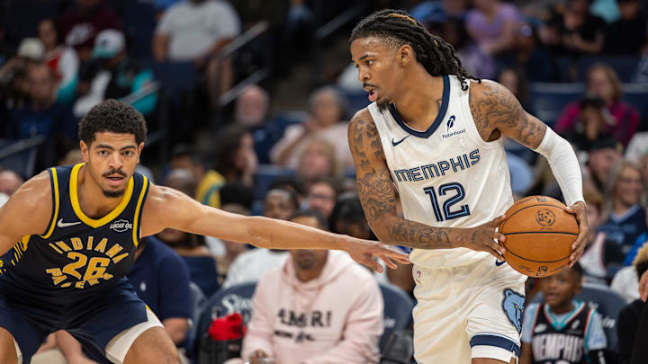 Oct 25, 2025; Memphis, Tennessee, USA; Memphis Grizzlies guard Ja Morant (12) handles the ball against Indiana Pacers guard Ben Sheppard (26) during the second half at FedExForum. Mandatory Credit: Wesley Hale-Imagn Images