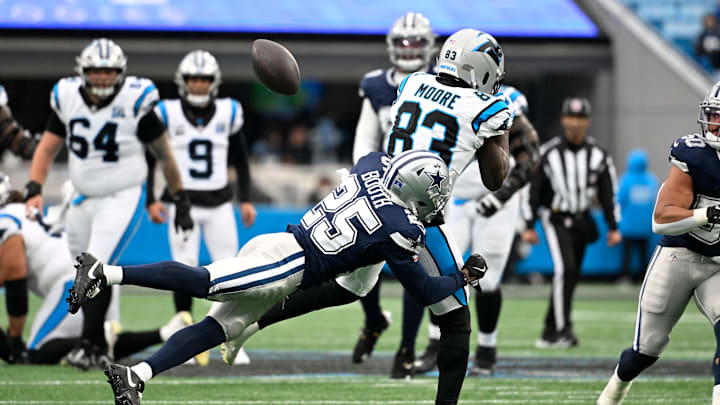 Dec 15, 2024; Charlotte, North Carolina, USA; Dallas Cowboys cornerback Andrew Booth Jr. (25) breaks up a pass intended for Carolina Panthers wide receiver David Moore (83) in the fourth quarter at Bank of America Stadium. Mandatory Credit: Bob Donnan-Imagn Images