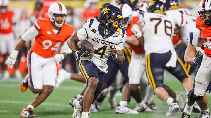 Sep 19, 2026; Charlotte, North Carolina, USA; West Virginia Mountaineers running back Cam Cook (4) runs the ball during the third quarter against the Virginia Cavaliers at Bank of America Stadium. Mandatory Credit: Ben Queen-Imagn Images Sep 19, 2026; Charlotte, North Carolina, USA; West Virginia Mountaineers running back Cam Cook (4) runs the ball during the third quarter against the Virginia Cavaliers at Bank of America Stadium. Mandatory Credit: Ben Queen-Imagn Images