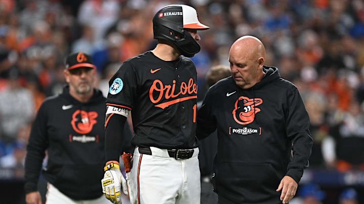 Oct 2, 2024; Baltimore, Maryland, USA; Baltimore Orioles outfielder Colton Cowser (17) is checked on by a trainer in the fifth inning against the Kansas City Royals in game two of the Wild Card round for the 2024 MLB Playoffs at Oriole Park at Camden Yards