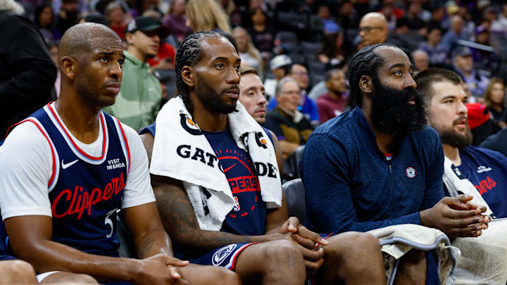 Oct 15, 2025; Sacramento, California, USA; Los Angeles Clippers guard Chris Paul (3) and forward Kawhi Leonard (2) and guard James Harden (1) sit on the bench during the fourth quarter against the Sacramento Kings at Golden 1 Center. Mandatory Credit: Sergio Estrada-Imagn Images
