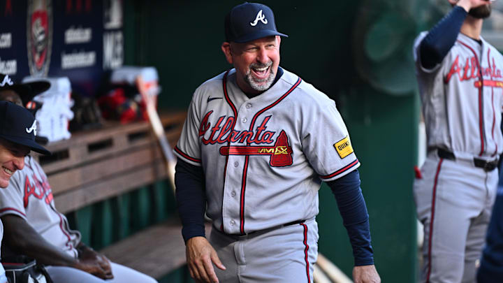 Apr 22, 2026; Washington, District of Columbia, USA;  Atlanta Braves manager Walt Weiss (22) laughs with other coaches in the dugout prior to the game against the Washington Nationals at Nationals Park. Mandatory Credit: Jamie Sabau-Imagn Images