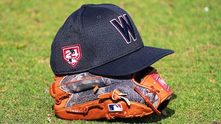 Feb 16, 2024; West Palm Beach, FL, USA; A Washington Nationals cap and glove rests in the outfield during workouts at spring training. Feb 16, 2024; West Palm Beach, FL, USA; A Washington Nationals cap and glove rests in the outfield during workouts at spring training.