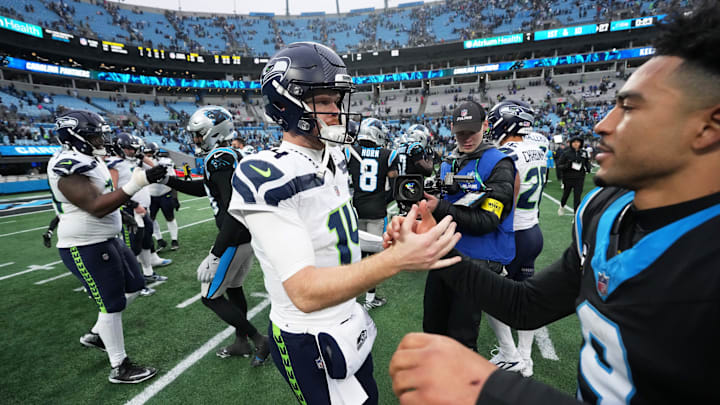 Seattle Seahawks quarterback Sam Darnold (14) shakes hands with Carolina Panthers quarterback Bryce Young