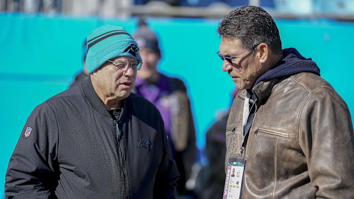Dec 22, 2024; Charlotte, North Carolina, USA; Panthers owner David Tepper talks with former Panthers head coach Ron Rivera  during pregame warmups at Bank of America Stadium. Mandatory Credit: Jim Dedmon-Imagn Images