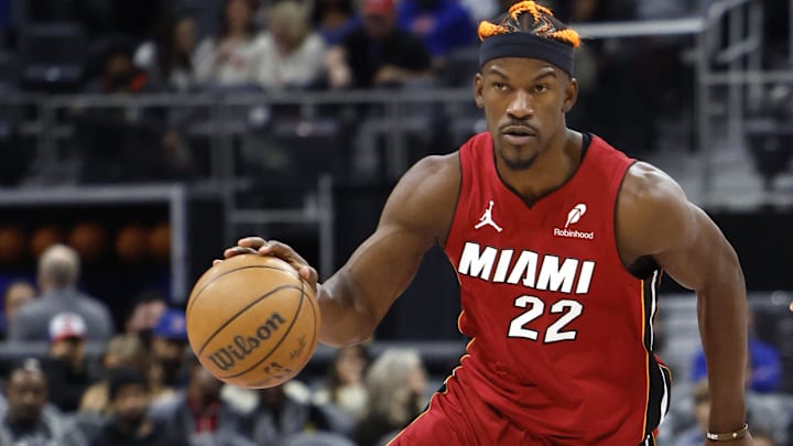 Dec 16, 2024; Detroit, Michigan, USA;  Miami Heat forward Jimmy Butler (22) dribbles as Detroit Pistons guard Cade Cunningham (2) defends in the first half at Little Caesars Arena. Mandatory Credit: Rick Osentoski-Imagn Images