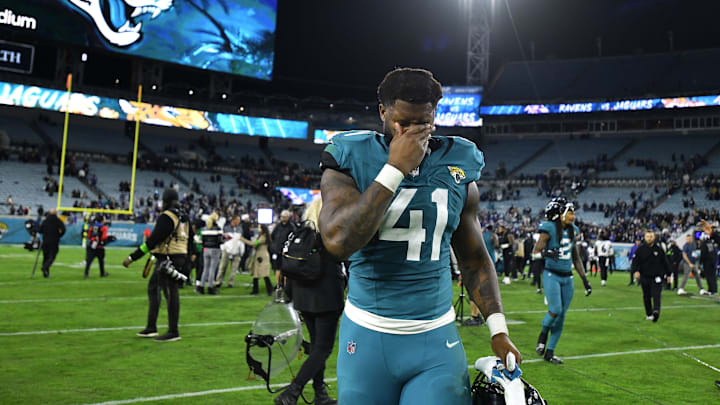 Jacksonville Jaguars linebacker Josh Allen (41) wipes his face as he walks off the field after