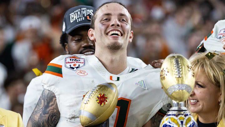 Jan 8, 2026; Glendale, AZ, USA; Miami Hurricanes quarterback Carson Beck (11) celebrates with the trophy after defeating the Mississippi Rebels during the 2026 Fiesta Bowl and semifinal game of the College Football Playoff at State Farm Stadium. Mandatory Credit: Mark J. Rebilas-Imagn Images