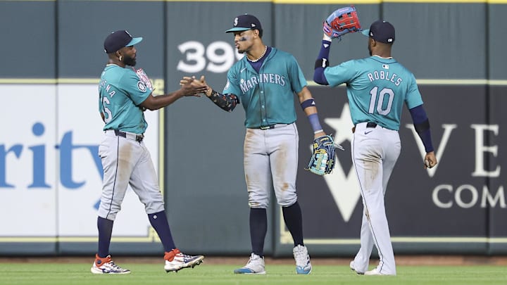 Seattle Mariners center fielder Julio Rodriguez (center) celebrates with left fielder Randy Arozarena (left) and right fielder Victor Robles after a game against the Houston Astros on Sept. 23 at Minute Maid Park.
