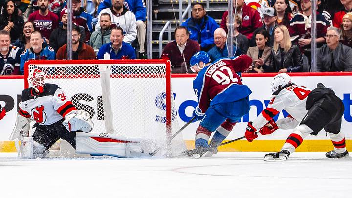 Jake Allen and Luke Hughes of the New Jersey Devils watch as Gabriel Landeskog of the Colorado Avalanche scores. Jake Allen and Luke Hughes of the New Jersey Devils watch as Gabriel Landeskog of the Colorado Avalanche scores.