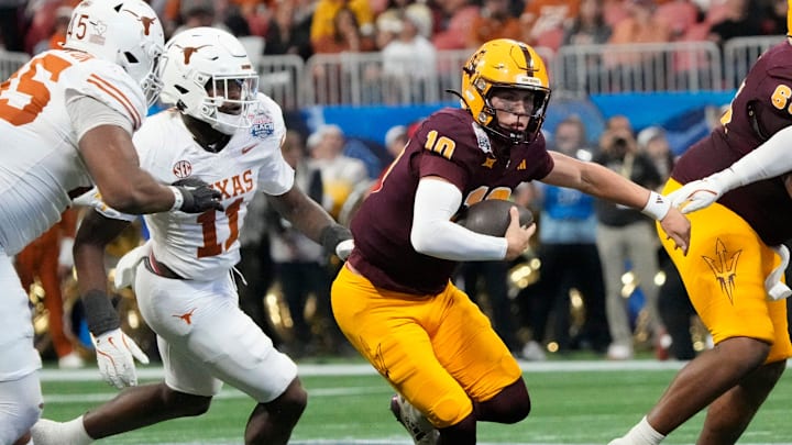 Arizona State quarterback Sam Leavitt (10) scrambles away from Texas linebacker Colin Simmons (11) during the second quarter of the Chick-fil-A Peach Bowl in Atlanta on Wednesday, Jan. 1, 2025.