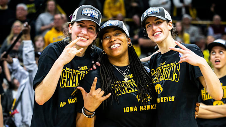 Iowa guards Kate Martin, left, and Caitlin Clark pose for a photo with Iowa assistant coach Raina Harmon after a NCAA Big Ten Conference women's basketball game against Michigan, Sunday, Feb. 27, 2022, at Carver-Hawkeye Arena in Iowa City, Iowa.