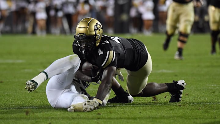 Sep 21, 2024; Boulder, Colorado, USA; Colorado Buffaloes wide receiver Omarion Miller (4) stays on his feet to score after a tackle attempt from Baylor Bears safety Corey Gordon Jr. (24) during the first half at Folsom Field. Mandatory Credit: Christopher Hanewinckel-Imagn Images