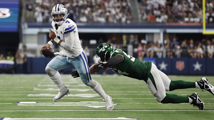 Dallas Cowboys quarterback Dak Prescott is chased by New York Jets defensive end Solomon Thomas.