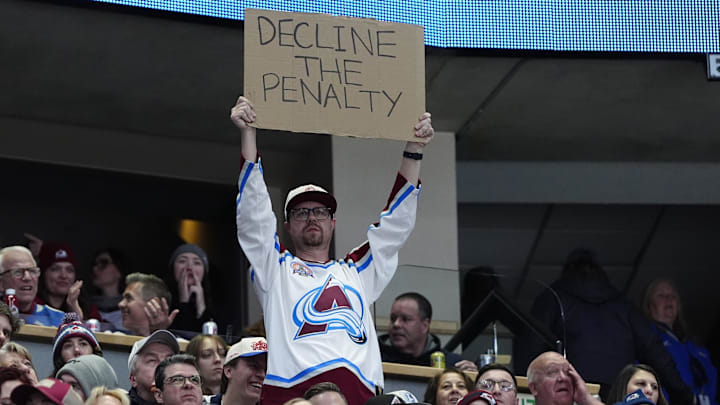 Dec 19, 2025; Denver, Colorado, USA; Colorado Avalanche fan holds a sign in the second period against the Winnipeg Jets at Ball Arena. Mandatory Credit: Ron Chenoy-Imagn Images