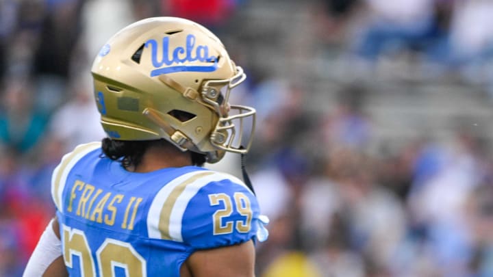 Nov 30, 2024; Pasadena, California, USA; UCLA Bruins head coach DeShaun Foster greets UCLA Bruins running back Anthony Frias II (29) as he returns to the bench during the third quarter against the Fresno State Bulldogs at Rose Bowl. Mandatory Credit: Robert Hanashiro-Imagn Images