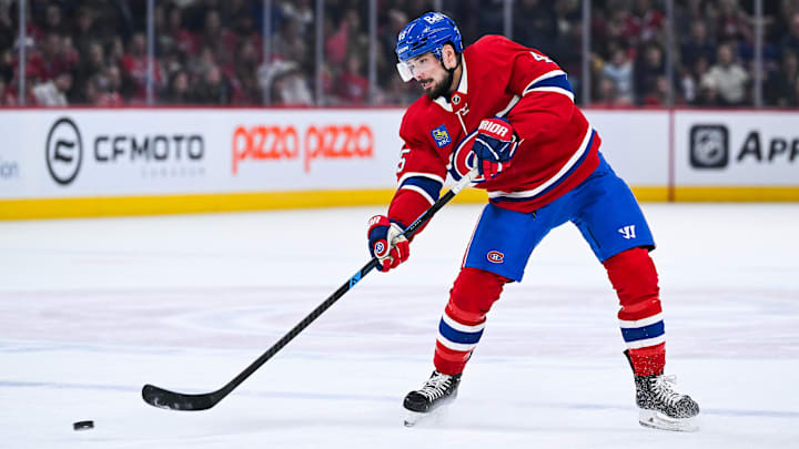 Mar 21, 2026; Montreal, Quebec, CAN; Montreal Canadiens defenseman Alexandre Carrier (45) shoots the puck against the New York Islanders during the first period at Bell Centre. Mandatory Credit: David Kirouac-Imagn Images
