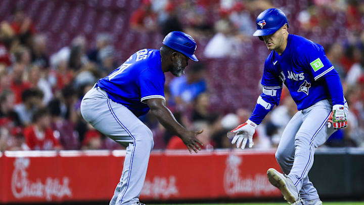 Sep 2, 2025; Cincinnati, Ohio, USA; Toronto Blue Jays outfielder Daulton Varsho (5) high fives third base coach Carlos Febles (51) after hitting a solo home run in the seventh inning against the Cincinnati Reds at Great American Ball Park. Sep 2, 2025; Cincinnati, Ohio, USA; Toronto Blue Jays outfielder Daulton Varsho (5) high fives third base coach Carlos Febles (51) after hitting a solo home run in the seventh inning against the Cincinnati Reds at Great American Ball Park.