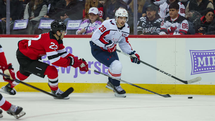 Nov 30, 2024; Newark, New Jersey, USA; Washington Capitals center Hendrix Lapierre (29) moves the puck while New Jersey Devils defenseman Brett Pesce (22) defends during the first period at Prudential Center. Mandatory Credit: Thomas Salus-Imagn Images Nov 30, 2024; Newark, New Jersey, USA; Washington Capitals center Hendrix Lapierre (29) moves the puck while New Jersey Devils defenseman Brett Pesce (22) defends during the first period at Prudential Center. Mandatory Credit: Thomas Salus-Imagn Images