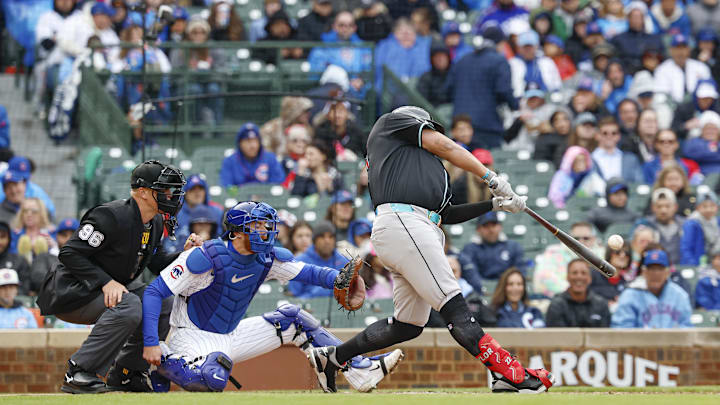 Apr 20, 2025; Chicago, Illinois, USA; Arizona Diamondbacks designated hitter Josh Naylor (22) hits an RBI-single against the Chicago Cubs during the fourth inning at Wrigley Field. Mandatory Credit: Kamil Krzaczynski-Imagn Images
