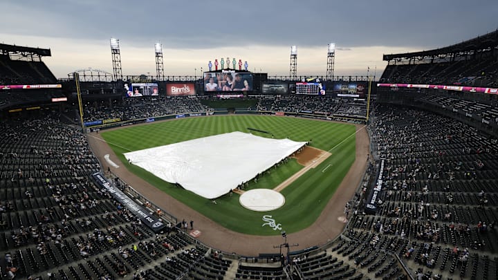 Chicago White Sox grounds crew pulls out the tarp during a rain delay on Thursday against the Cleveland Guardians at Rate Field. Chicago White Sox grounds crew pulls out the tarp during a rain delay on Thursday against the Cleveland Guardians at Rate Field.